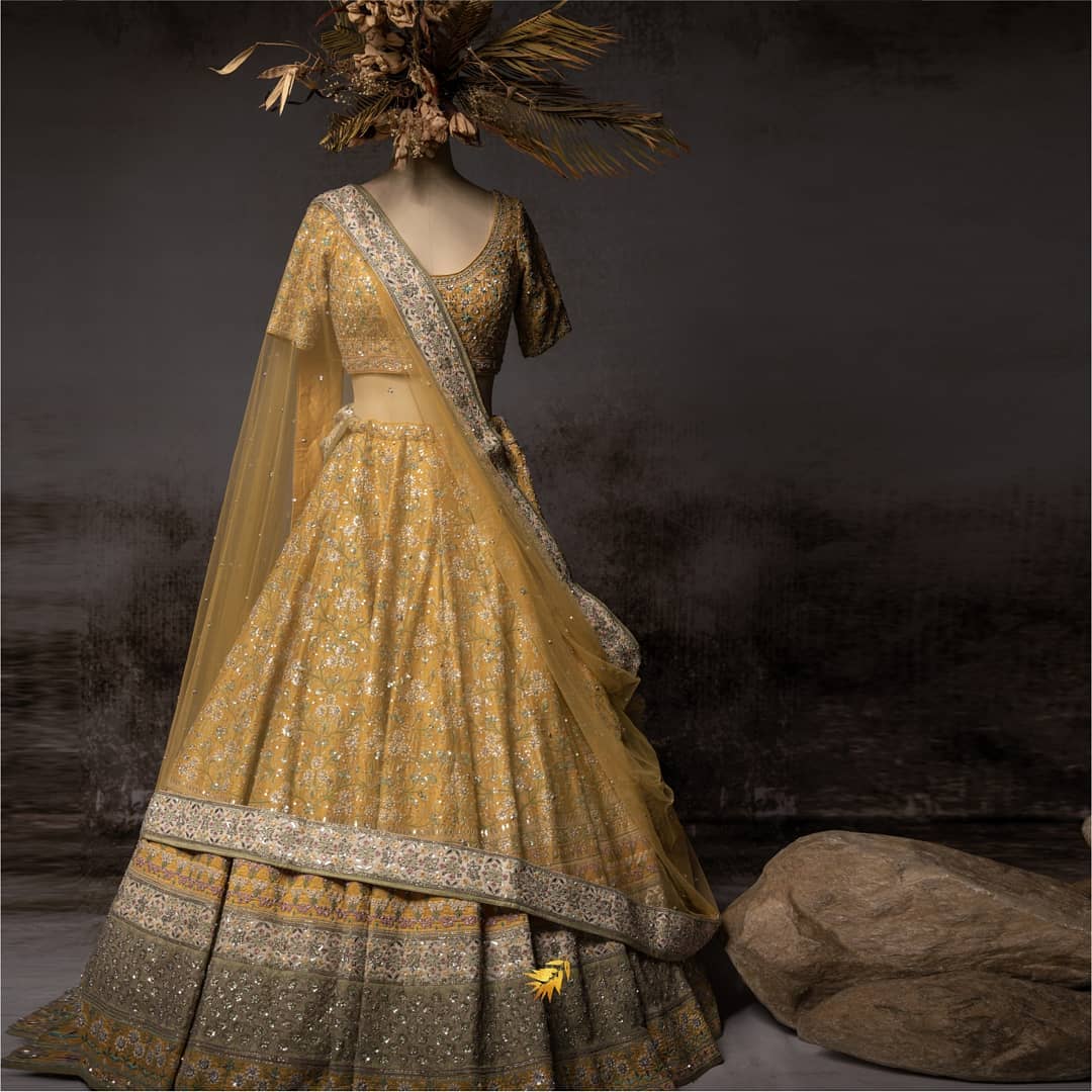 Glamourous yellow bridal lehnga with silver embroidery