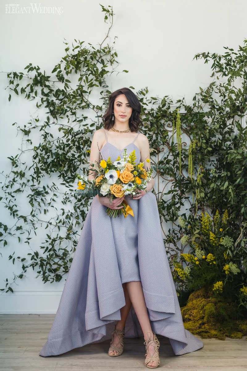 And elegant gray gown complimented by a yellow bouquet