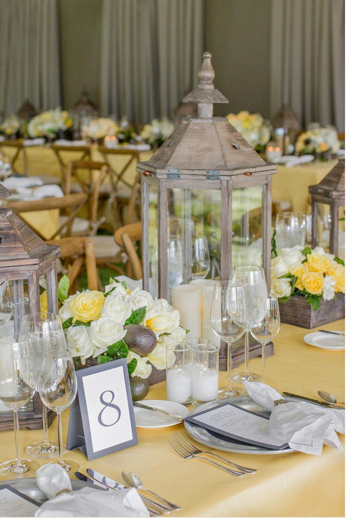 Summery table design with yellow florals and table cloths and gray accents